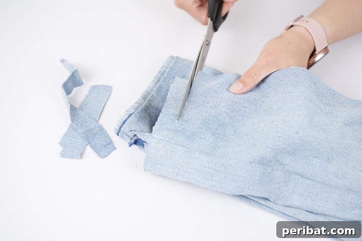 Denim Delight: Simple Wreath from Upcycled Jeans 2 black scissors cutting blue jeans into strips