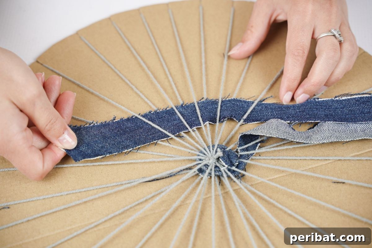 A hand holding a pen, carefully marking out measurements on a cardboard circle for the weaving frame.