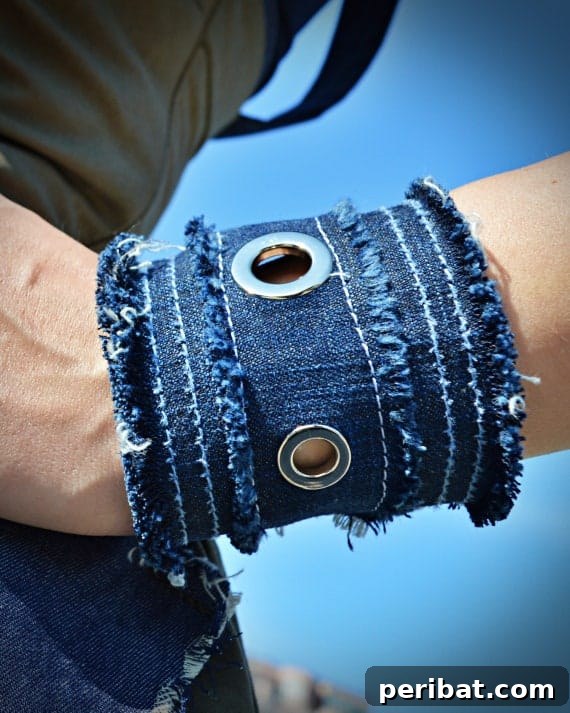 Denim Reborn Wristwear 21 Another view of a decorated denim wristband, showcasing different embellishments and a unique closure