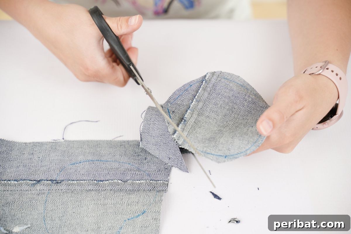 black scissors cutting denim