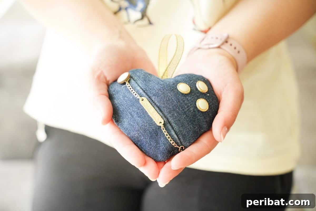 heart sachet with denim cover and gold accents beign held in hands
