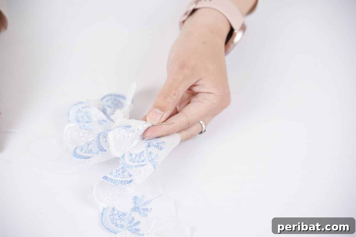 Upcycled Denim Storage Box 6 blue and white lace being sewn into round bow