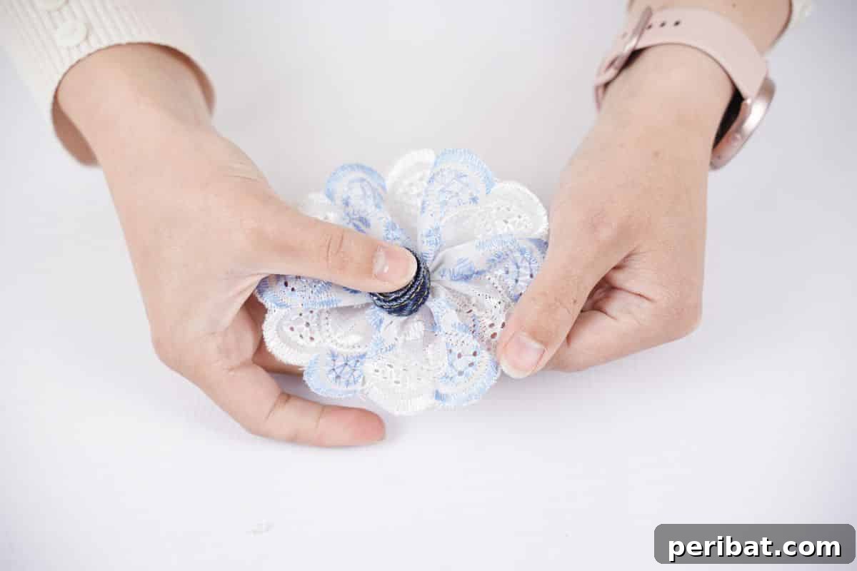 Upcycled Denim Storage Box 7 hand holding denim circle to center of white lace bow