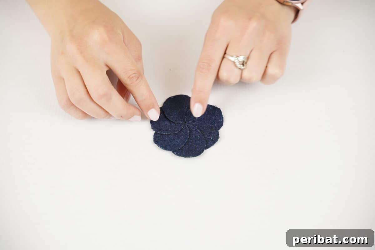 Blossoming Denim Transform Old Jeans into Flower Appliques 6 dark denim circles being overlapped into circle on white table
