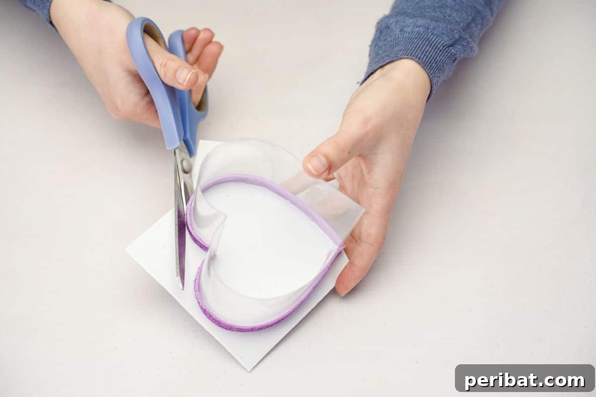 From Bottle to Heart: Upcycled Gift Box Craft 7 Cutting white foam paper to fit the bottom of the plastic heart box.