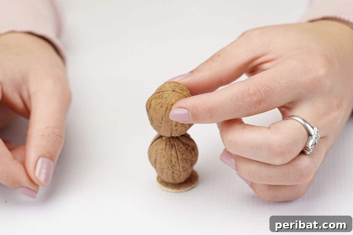 Enchanted Walnut Shell Fairy Garden Dweller 9 hand holding walnuts on top of cork