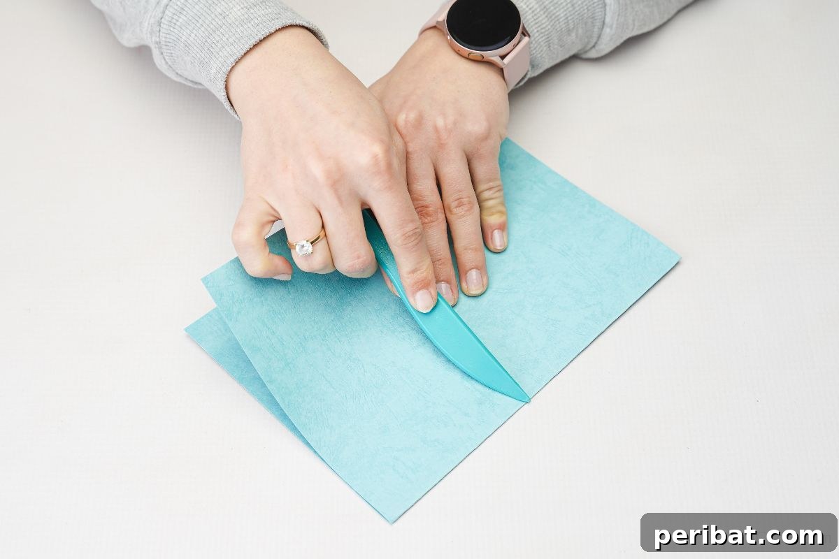 hand folding blue paper