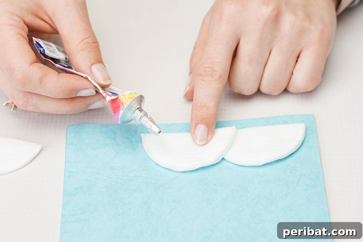 gluing white cotton pad onto bottom of card