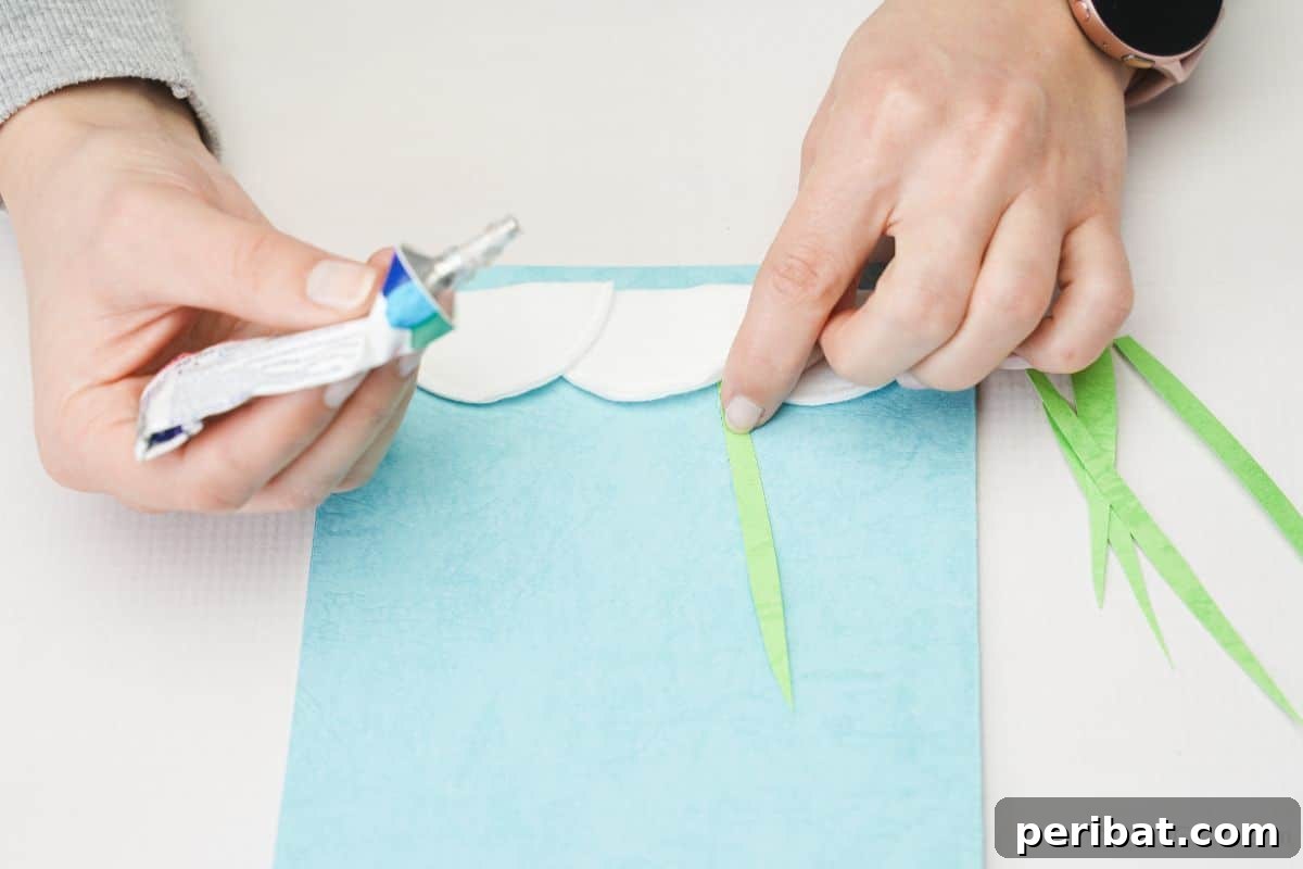 gluing green paper onto front of blue card