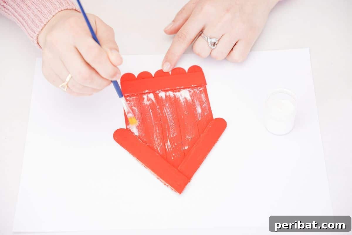 DIY Popsicle Stick Farmhouse Decor 5 white paint accents being added to craft stick house