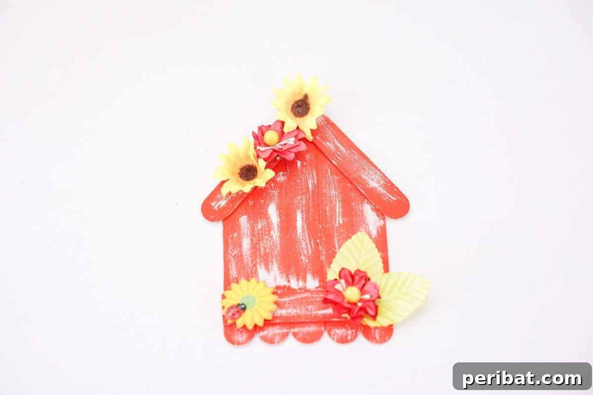 DIY Popsicle Stick Farmhouse Decor 6 orange and white craft stick house on white table
