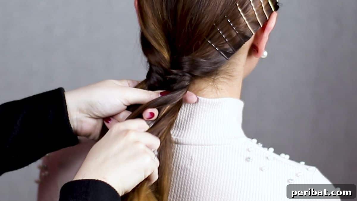 Braided Bobby Pin Glam 6 bobby pins against scalp while hand with red nails braids