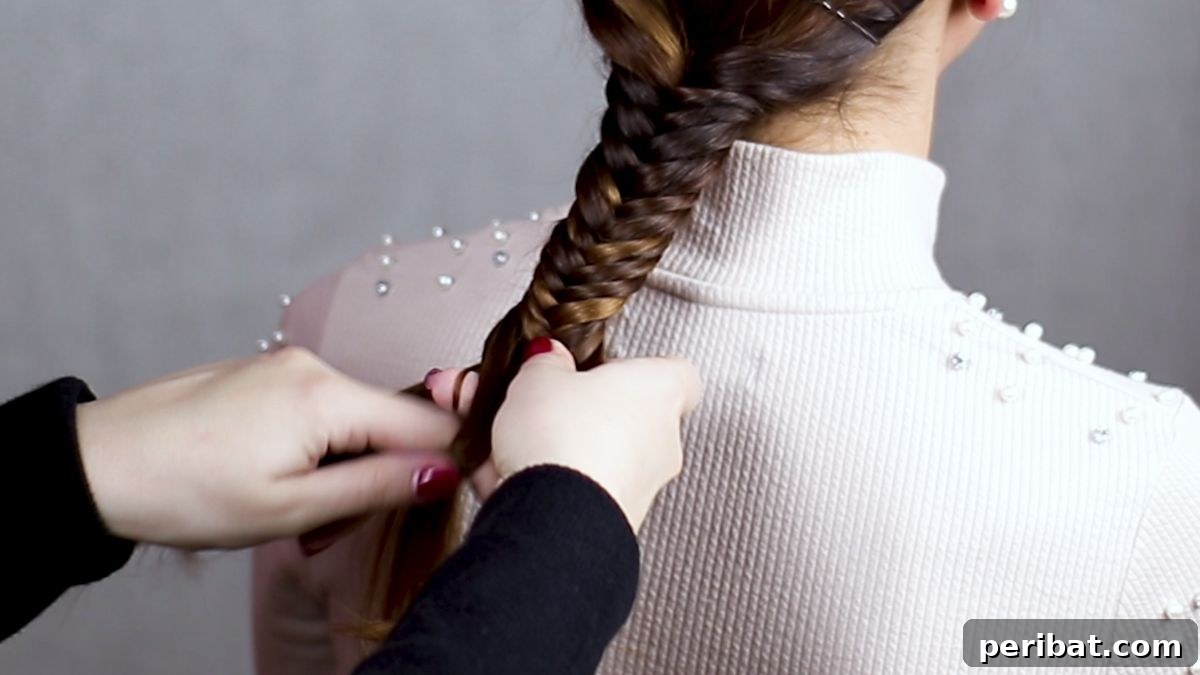 Braided Bobby Pin Glam 7 hands making a fishtail braid in brown hair