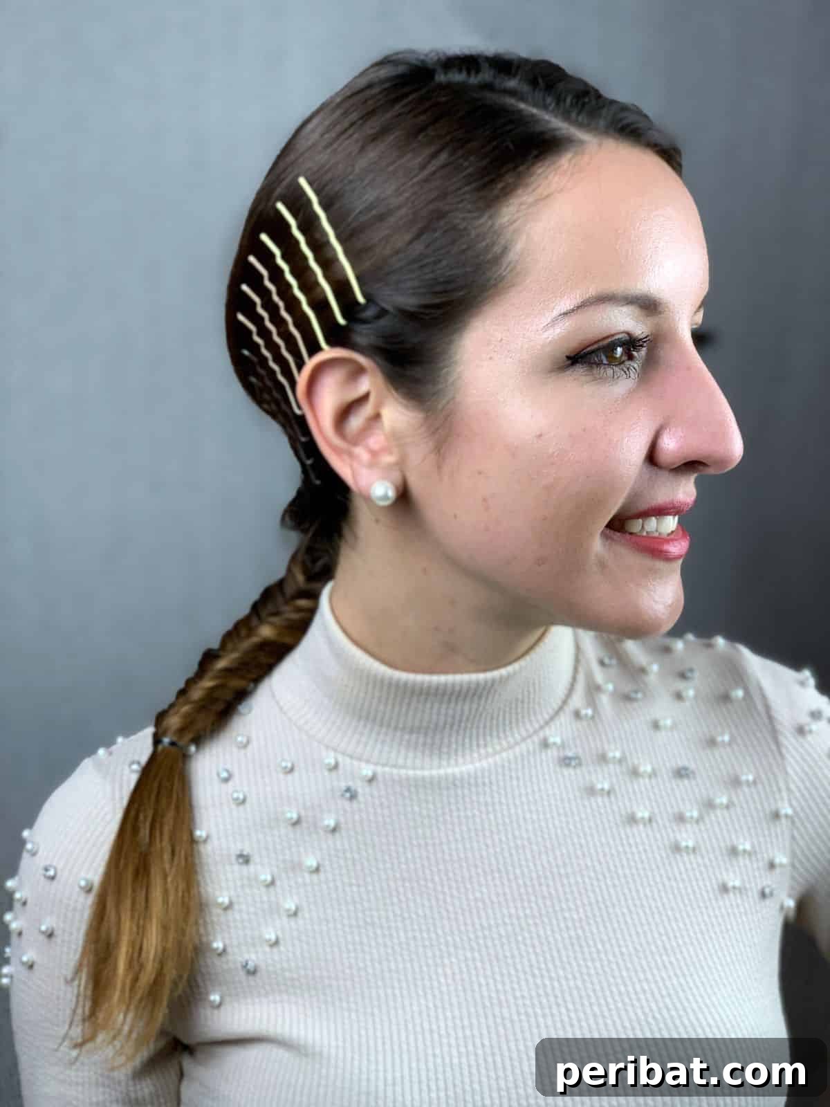 smiling woman with bobby pins on side above ears