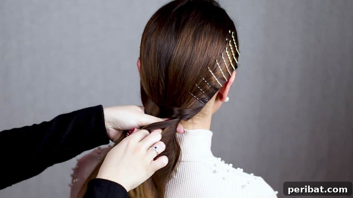 Braided Bobby Pin Glam 4 hand pulling hair over section at back of head