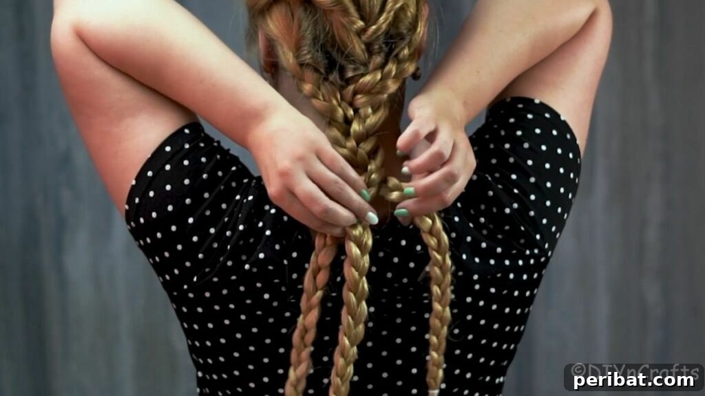 Boho Cascade Braids 4 three individual braids being braided together by woman in black