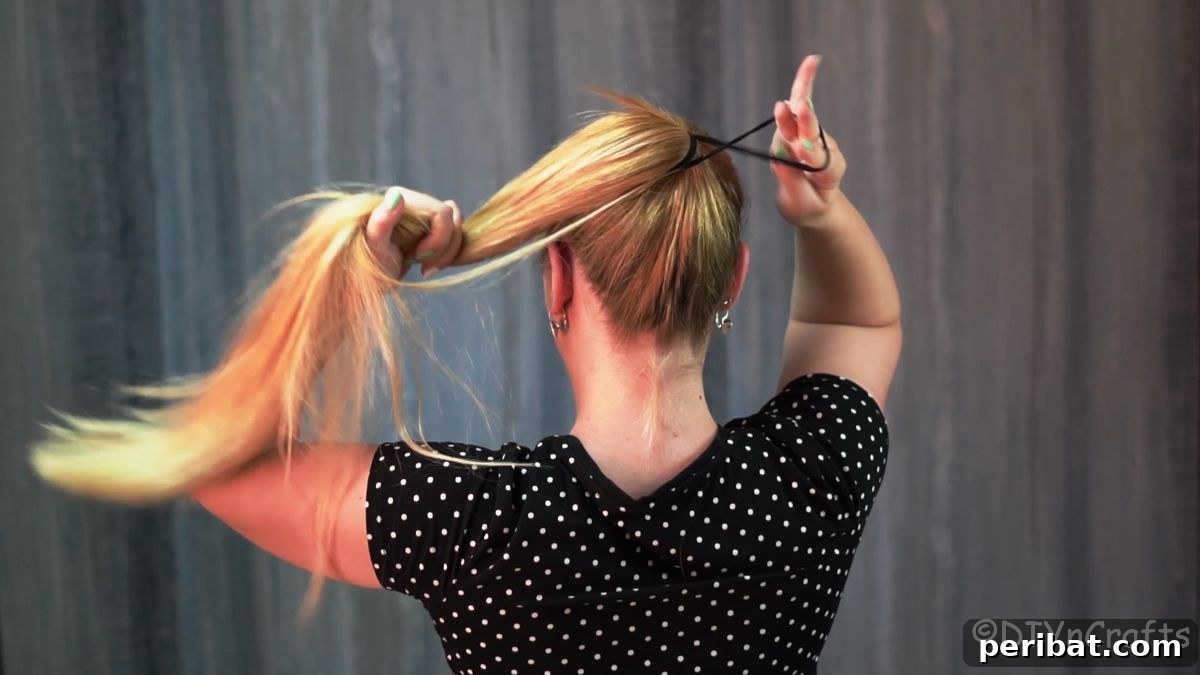 Stunning Braided Donut Bun Updo 5 Woman pulling her hair into a high, smooth ponytail, secured with an elastic.