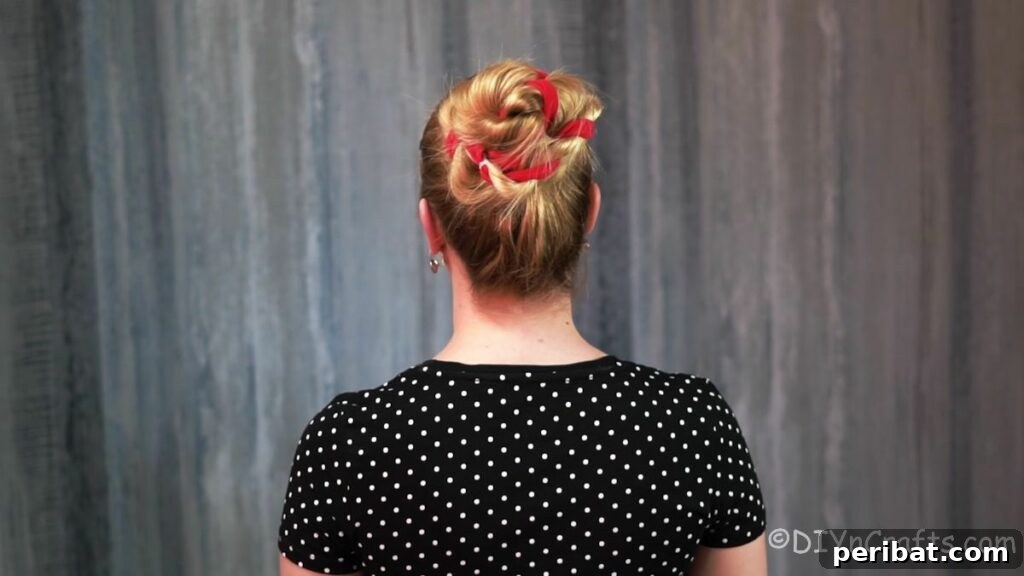 Twisted High Bun with Ribbon Accent 2 Elegant high twisted bun with red ribbon, viewed from the back, showcasing a sophisticated yet simple hairstyle perfect for various occasions.