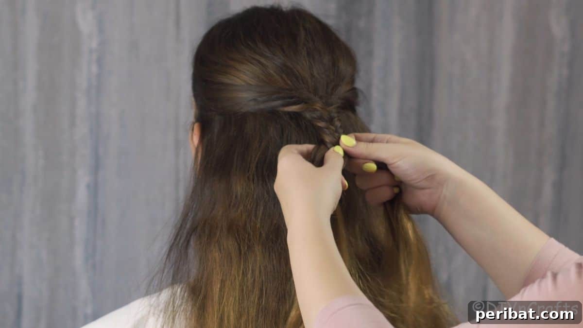 Fancy Palm Tree Bubble Braids Half-Updo 5 Side pieces of hair being pulled into the initial sections for the braid.