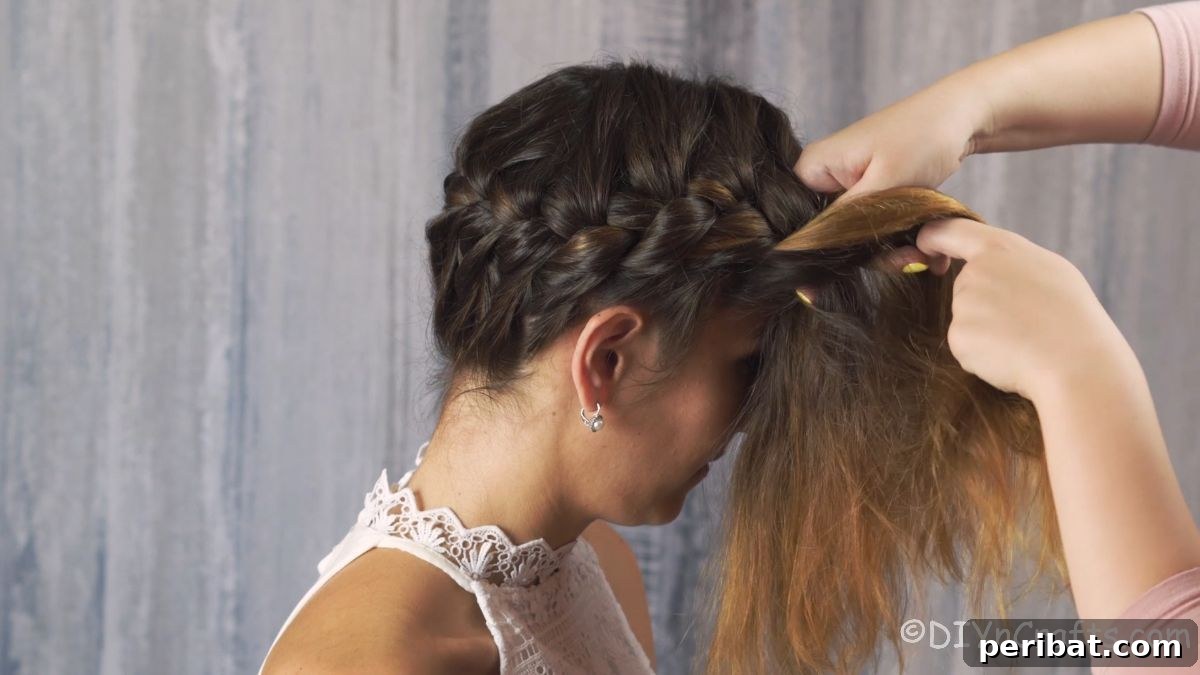 Whimsical French Crown Braid 8 braid being pulled around back and side of head