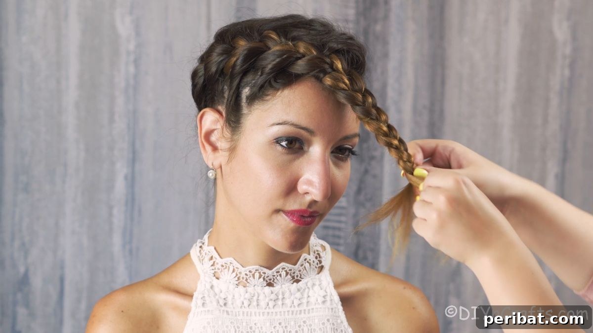 Whimsical French Crown Braid 10 end of french braid being braided on front of head