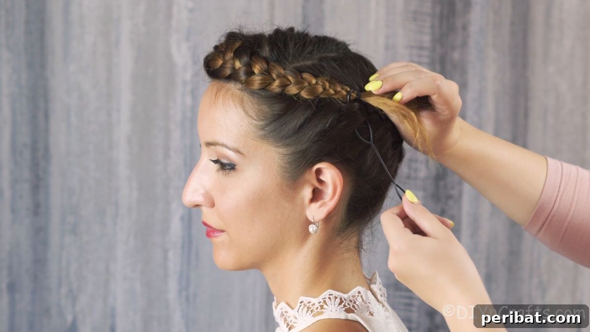 Whimsical French Crown Braid 11 hand securing side of braid