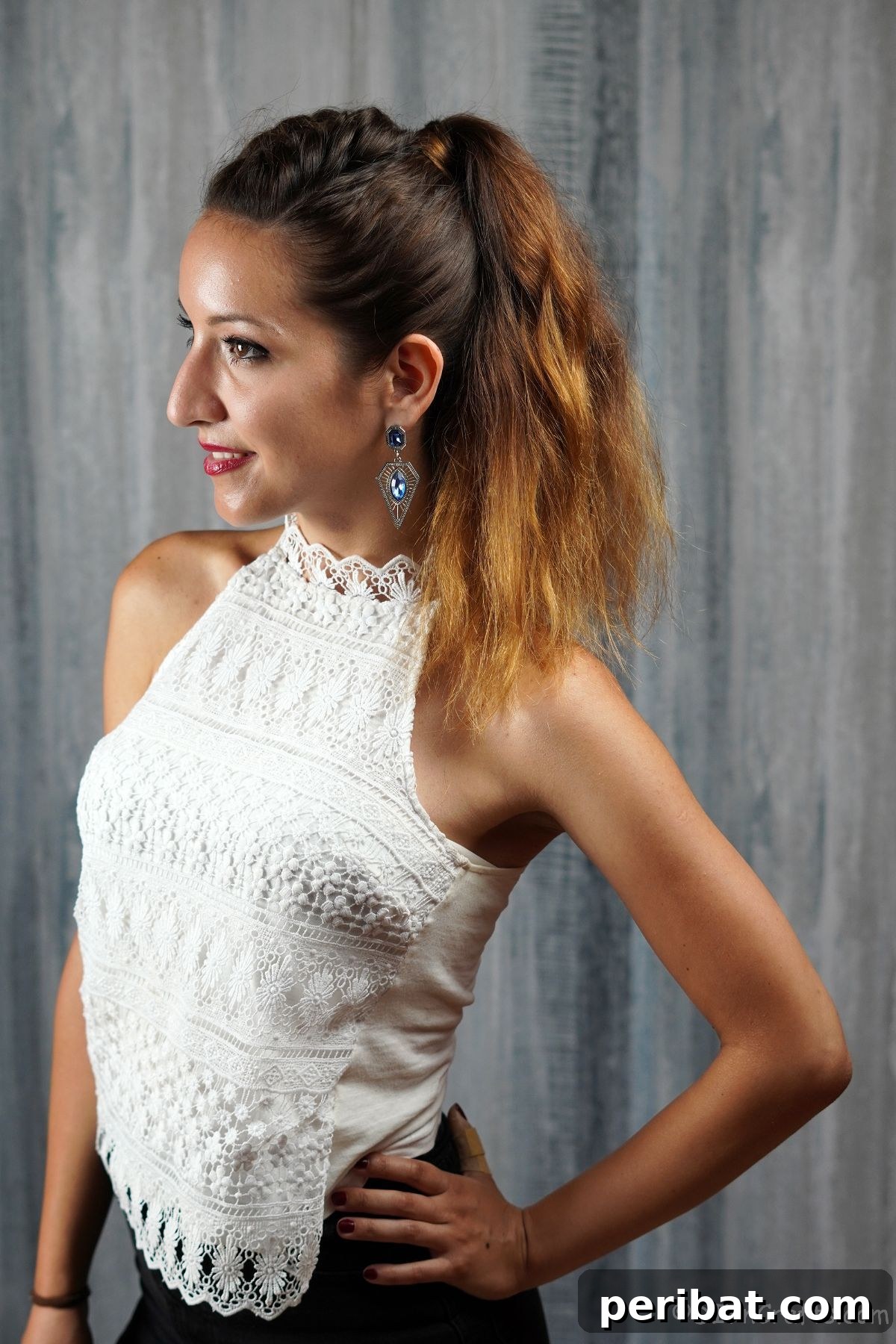 Stunning Half-Up French Braid Ponytail 11 A finished half braided high ponytail on a brunette woman in a white shirt, showcasing the completed style