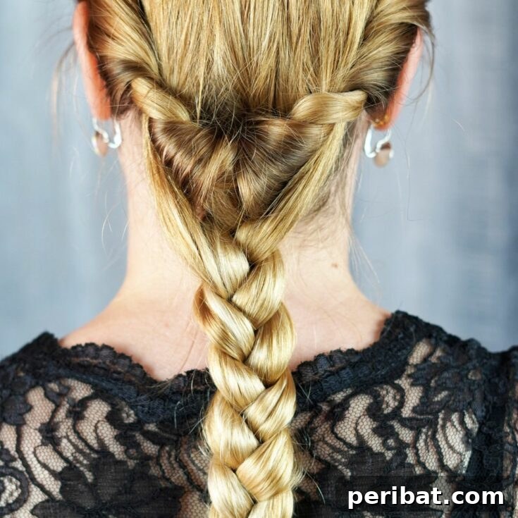 Artfully Twisted Low Braided Ponytail 2 Woman showcasing an elegant low ponytail braid with a twist