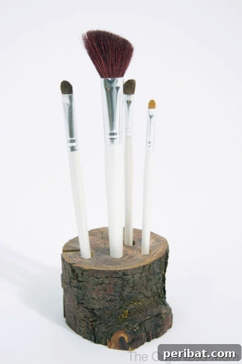 Makeup brushes stored upright in a natural wooden block with drilled holes