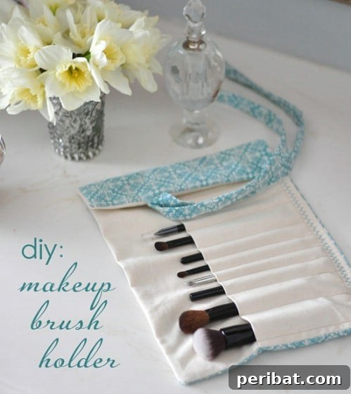 Fabric roll-up holder with individual pockets for makeup brushes