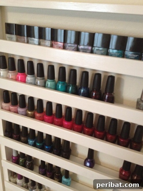 DIY wooden nail polish rack displaying multiple bottles of nail polish