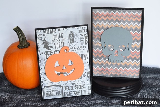 Halloween plaques depicting spooky characters nestled beside a decorative pumpkin, enhancing a festive autumn display.