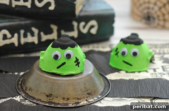 A charming Frankenstein monster crafted from an upcycled egg carton, displayed on a metal plate for a whimsical Halloween touch.