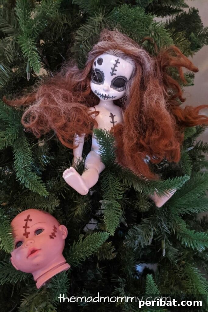 A trio of eerie, artfully arranged creepy dolls hanging from the branches of a tree, creating a truly haunted outdoor Halloween display.