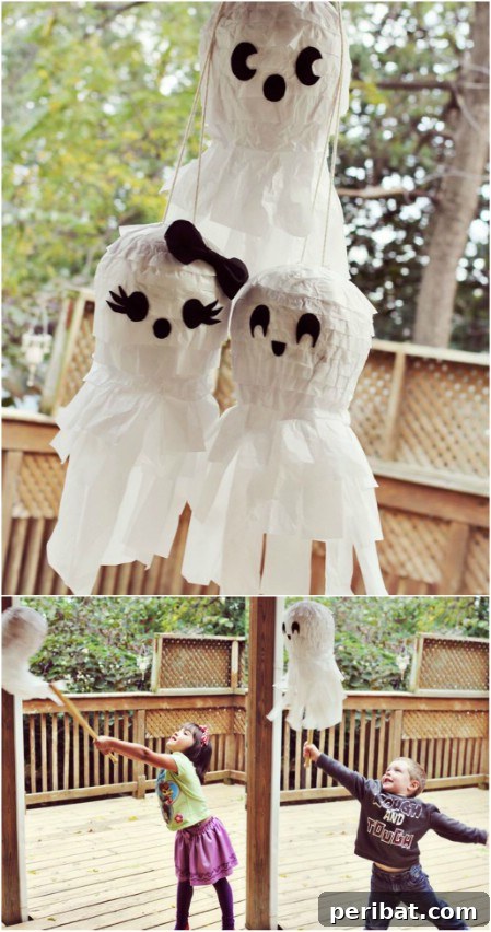 Two festive party piñatas, one shaped like a friendly ghost and the other a classic pumpkin, ready for a Halloween celebration.