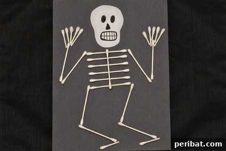 A whimsical Q-Tip skeleton art project, showcasing how everyday items can be transformed into creative Halloween decorations.