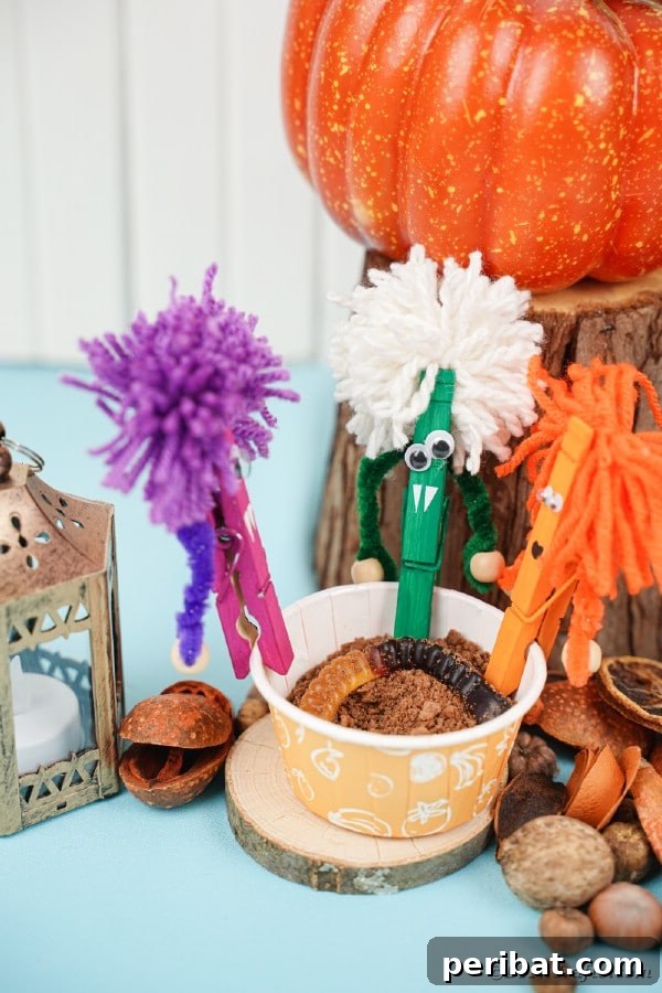 A collection of colorful and quirky clothespin monsters arranged with other Halloween decorations, showcasing their playful charm.