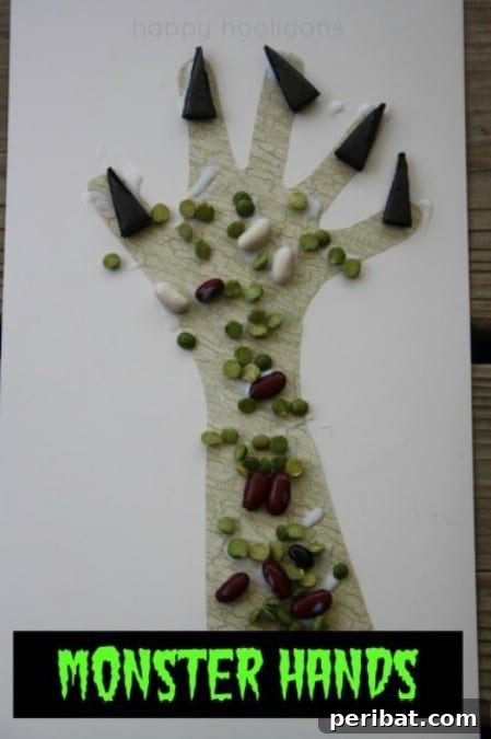 A creative monster hand craft, made with glued dried lentils and beans, showcasing a textured, eerie design for Halloween.