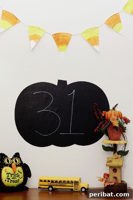 A cheerful candy corn banner, crafted from paper plates, strung together to create a festive and colorful Halloween decoration.