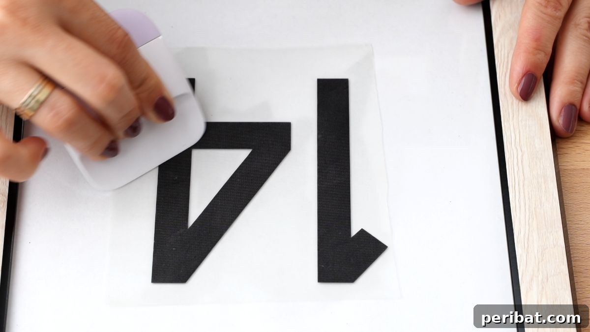 Create Custom Address Signs with Your Cricut 12 pressing vinyl numbers on frame
