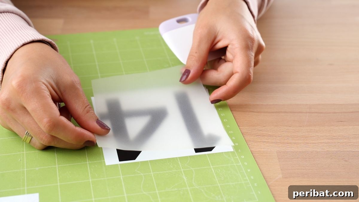 Create Custom Address Signs with Your Cricut 10 pressing transfer tape over house numbers on Cricut mat