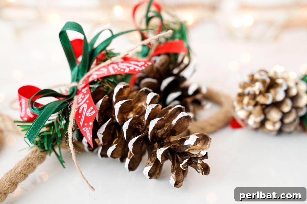 DIY Pinecone Christmas Ornaments 15 Two pinecone ornaments with red and green ribbon bows, showcasing intricate details and festive colors