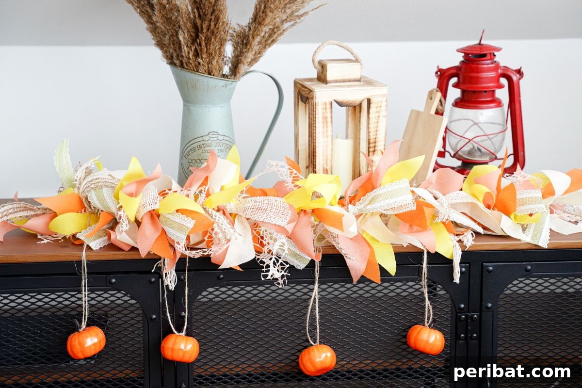 Fall rag garland draped over old lanterns and other autumn decorations on a wooden shelf