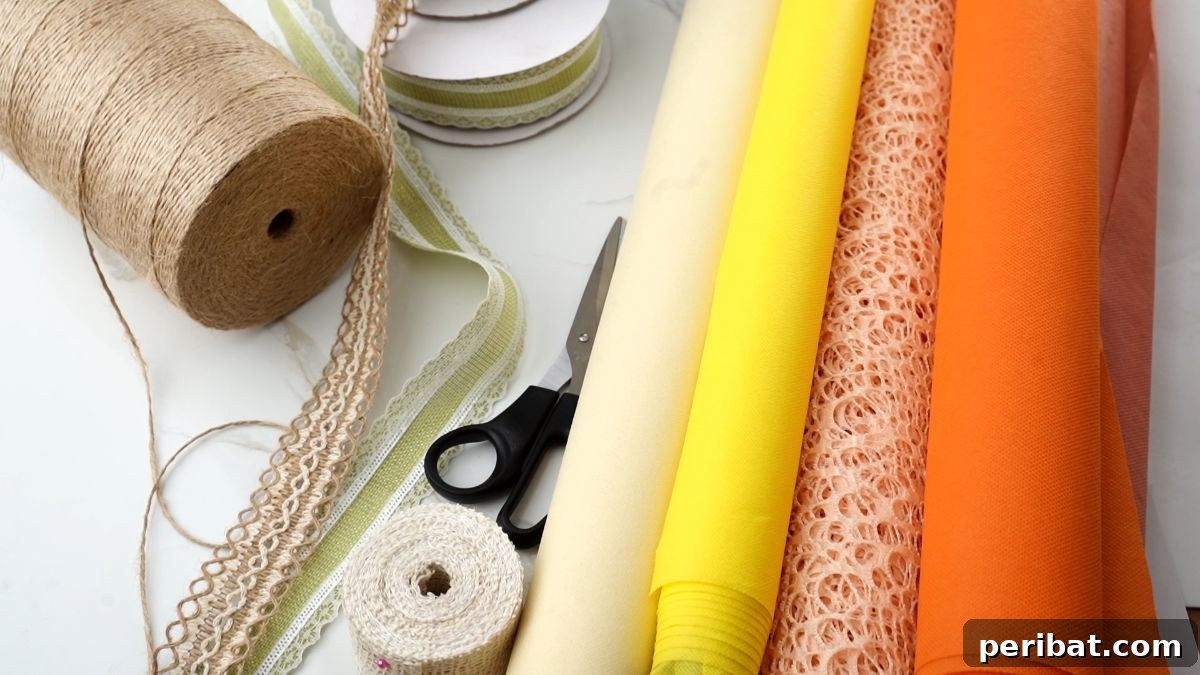 Close-up of various fall-colored fabric rolls, twine, and burlap lace, ready for crafting