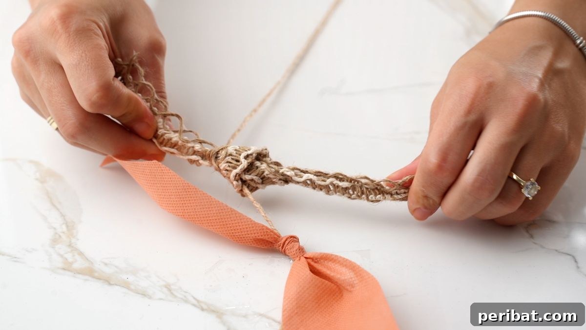 Hands tying a red and white checkered ribbon onto a piece of twine