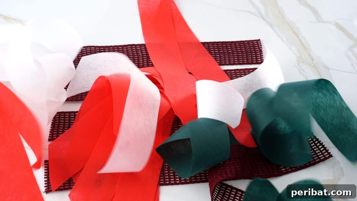 Handcrafted Rustic Christmas Rag Garland 6 strips of red, green, white, and maroon fabric on marble table