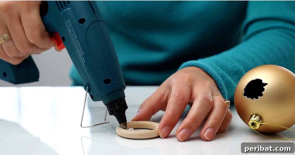 Crafting Festive Succulent Baubles 5 Detailed step-by-step on how to make a Christmas ornament succulent planter, showing the process of creating the initial opening.