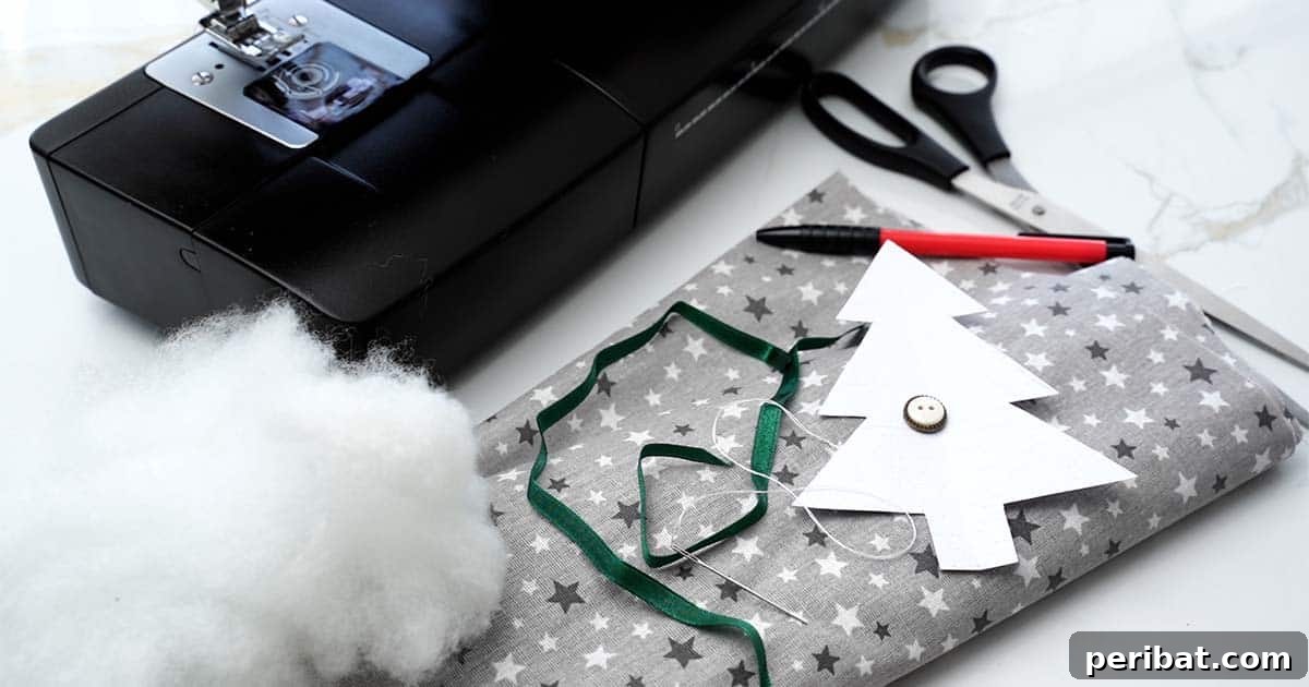 A flat lay of all the supplies needed to make DIY Fabric Christmas Tree Ornaments: fabric, scissors, ribbon, filling, needle and thread, button