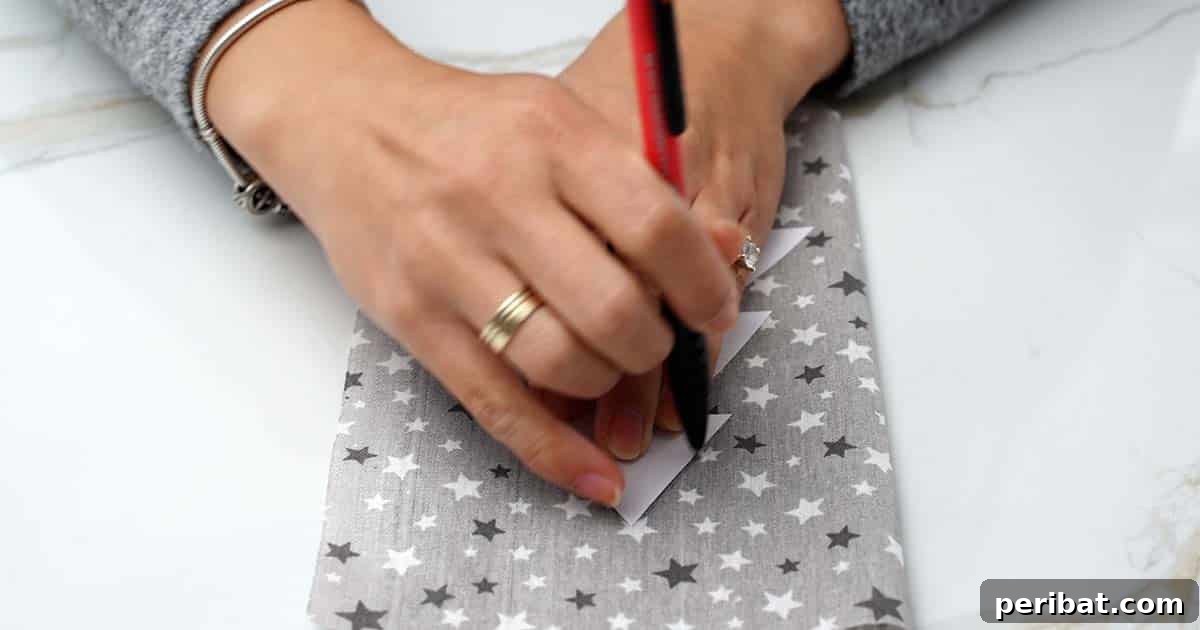 Tracing a Christmas tree template onto folded fabric with a pen