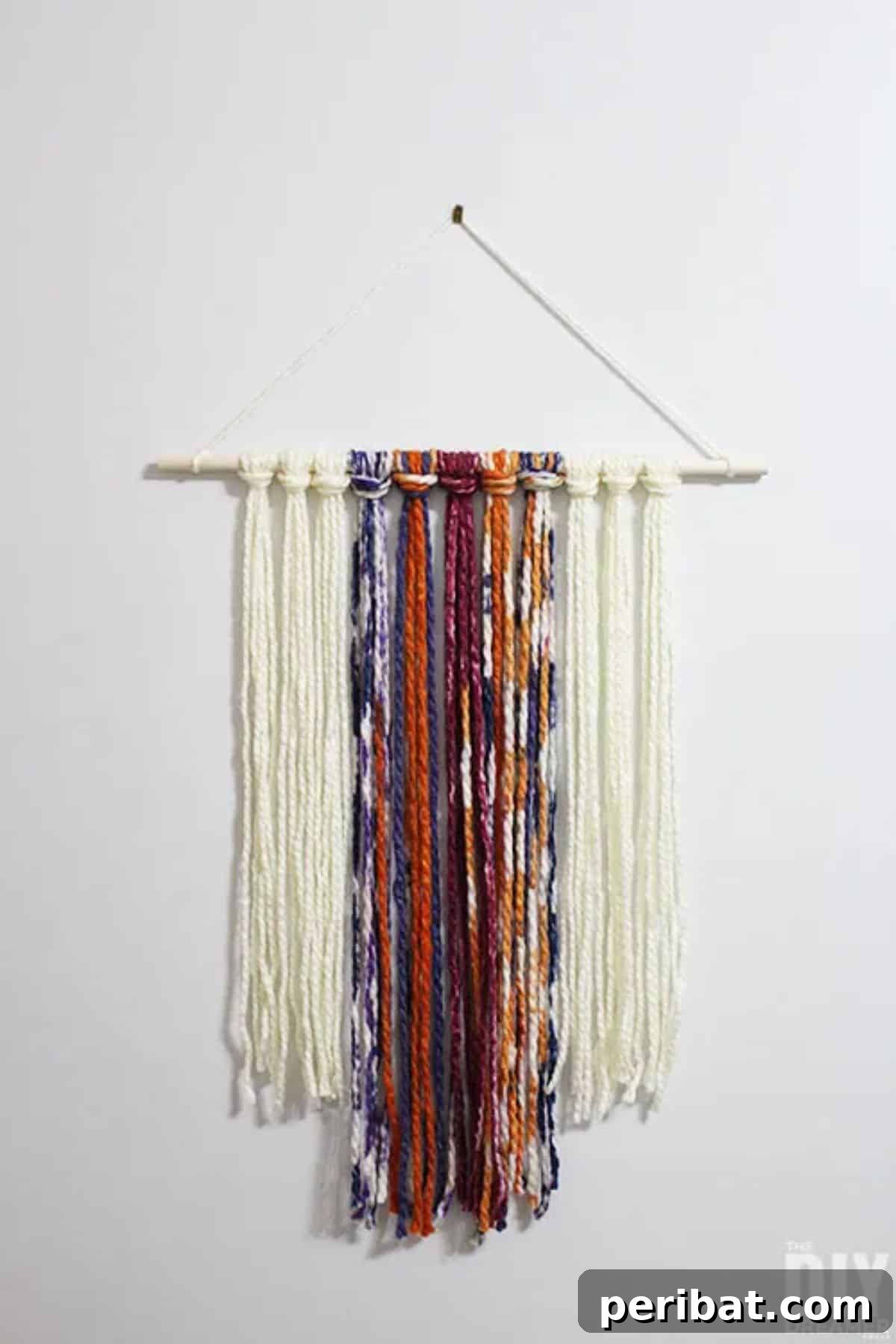 120 Inspiring DIY Boho Decor Ideas and Projects 28 Kid-friendly colorful yarn wall hanging, a beautiful and meaningful keepsake showcasing creative skills.